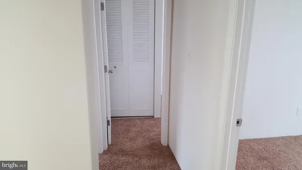 a view of hallway with closet