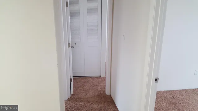 a view of hallway with closet