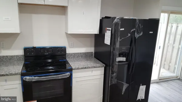 a kitchen with a refrigerator and a stove