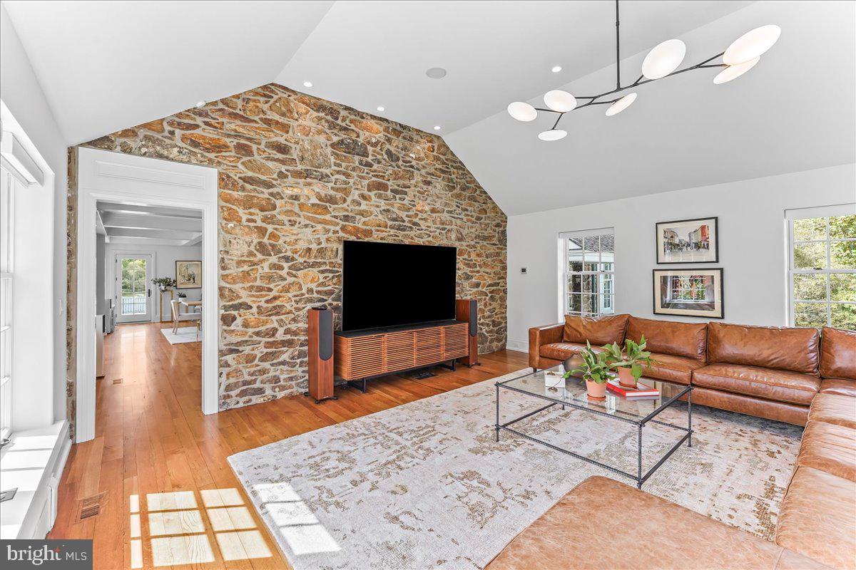 80 Heyburn Road Chadds Ford, PA 19317 - Photo 32 of 76 a living room with furniture a flat screen tv and a fireplace