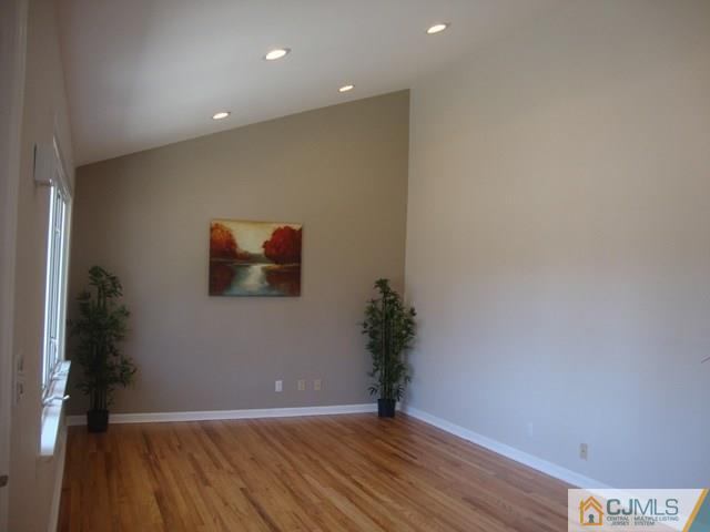 90 Westminster Road Colonia, NJ 07067 - Photo 4 of 25 a view of an empty room with wooden floor