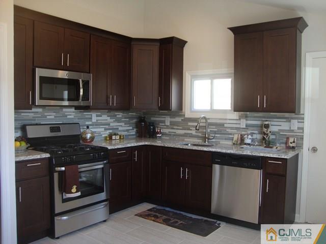 90 Westminster Road Colonia, NJ 07067 - Photo 7 of 25 a kitchen with sink a microwave and cabinets