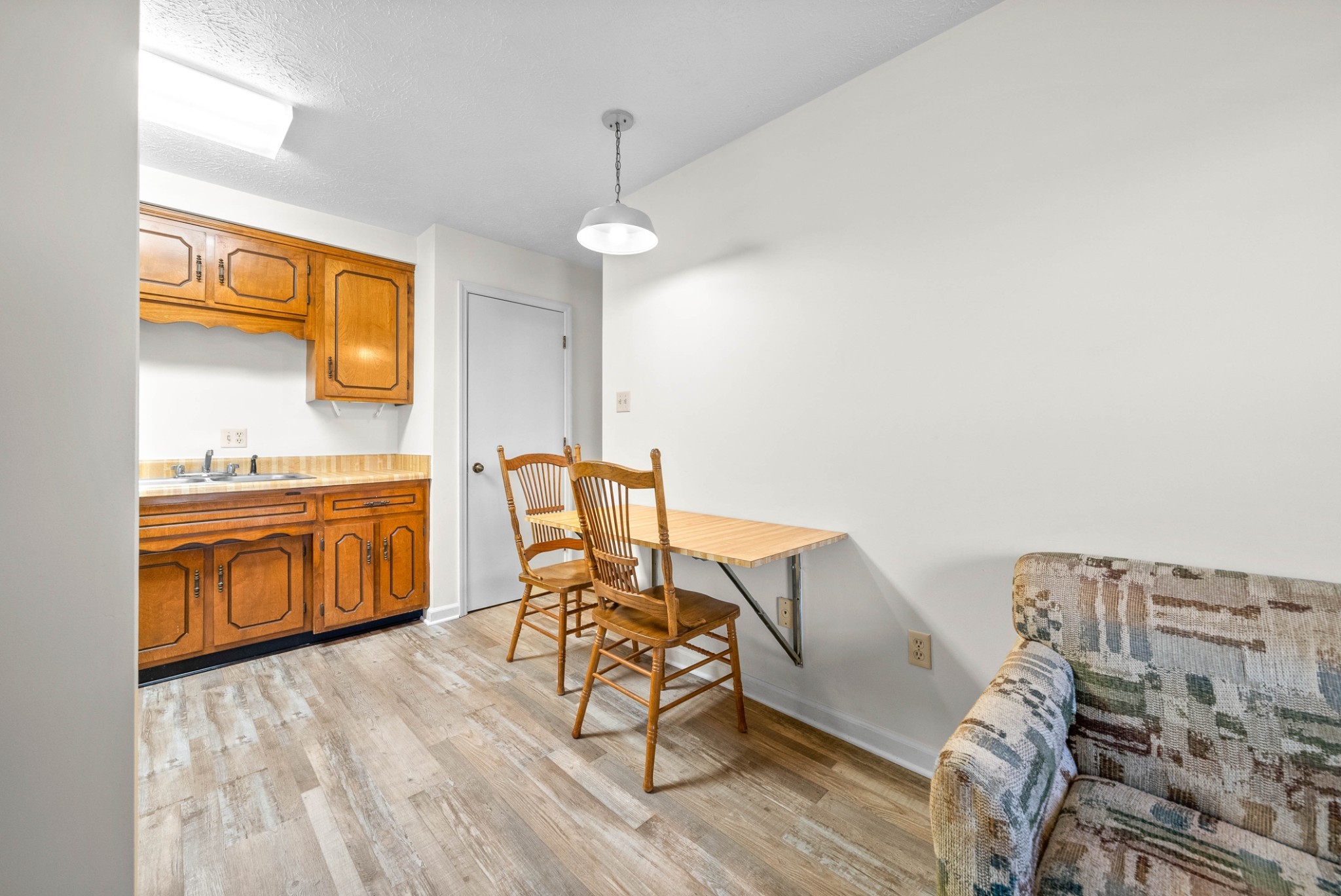100 Laurel Cove Drive, Unit 8 Hopkinsville, KY 42240 - Photo 5 of 13 a kitchen that has a table chairs and a wooden floor