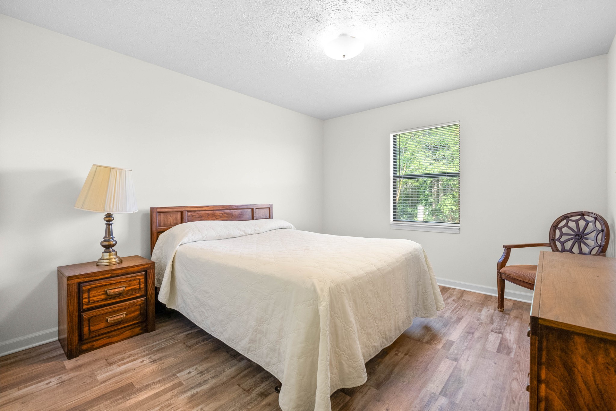 100 Laurel Cove Drive, Unit 8 Hopkinsville, KY 42240 - Photo 9 of 13 a bedroom with a bed and a lamp on table