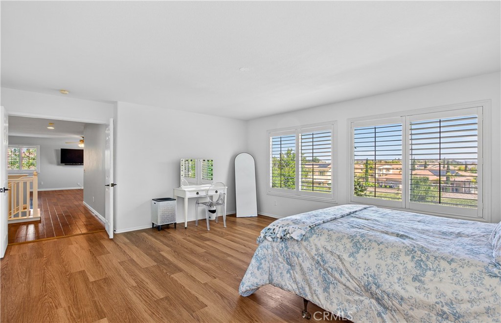 31928 Cercle Chambertin Temecula, CA 92591 - Photo 35 of 74 a spacious bedroom with a large bed and a large window