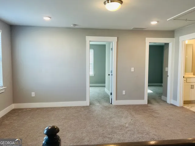 an empty room with closet and a window