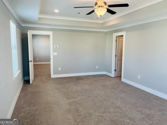 a view of an empty room with a ceiling fan