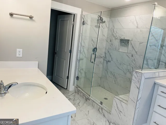 a bathroom with a sink and shower