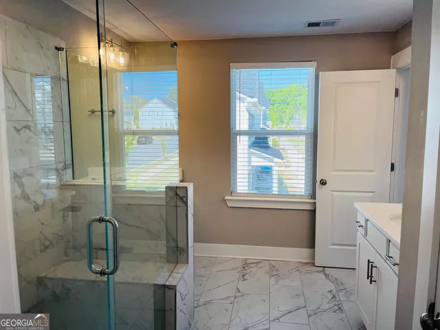a bathroom with a tub shower and sink