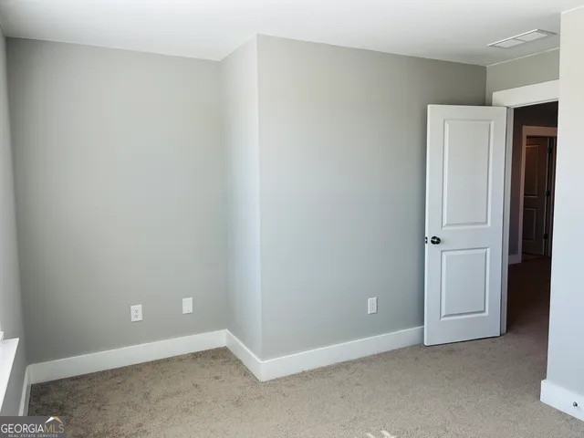 an empty room with closet area