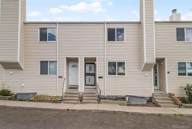 a view of a house with a yard and garage