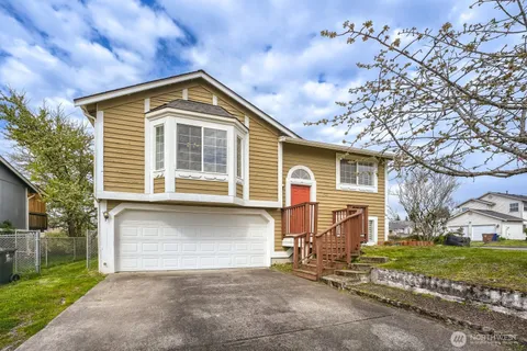 a front view of a house with a yard and garage