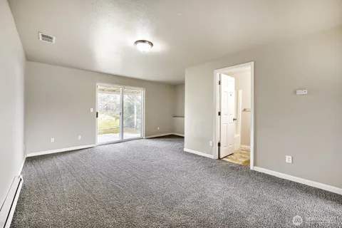 an empty room with windows and closet
