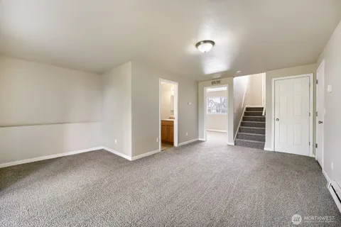 a view of an empty room with stairs and ventilation