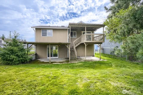 a front view of a house with a garden