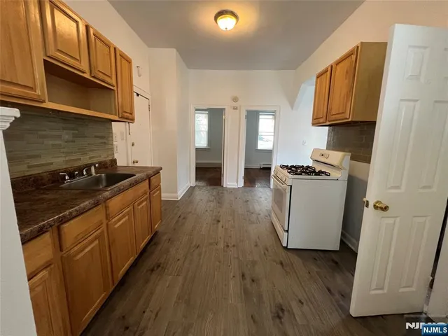 a kitchen with sink a refrigerator and a stove
