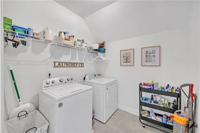 a bedroom with a bed a chandelier and a dresser