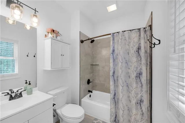 a view of walk in closet with clothes