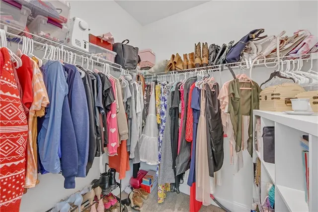 a bedroom with a bed a couch and dresser