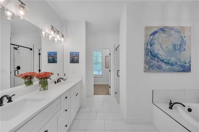 a bathroom with a bathtub and a window