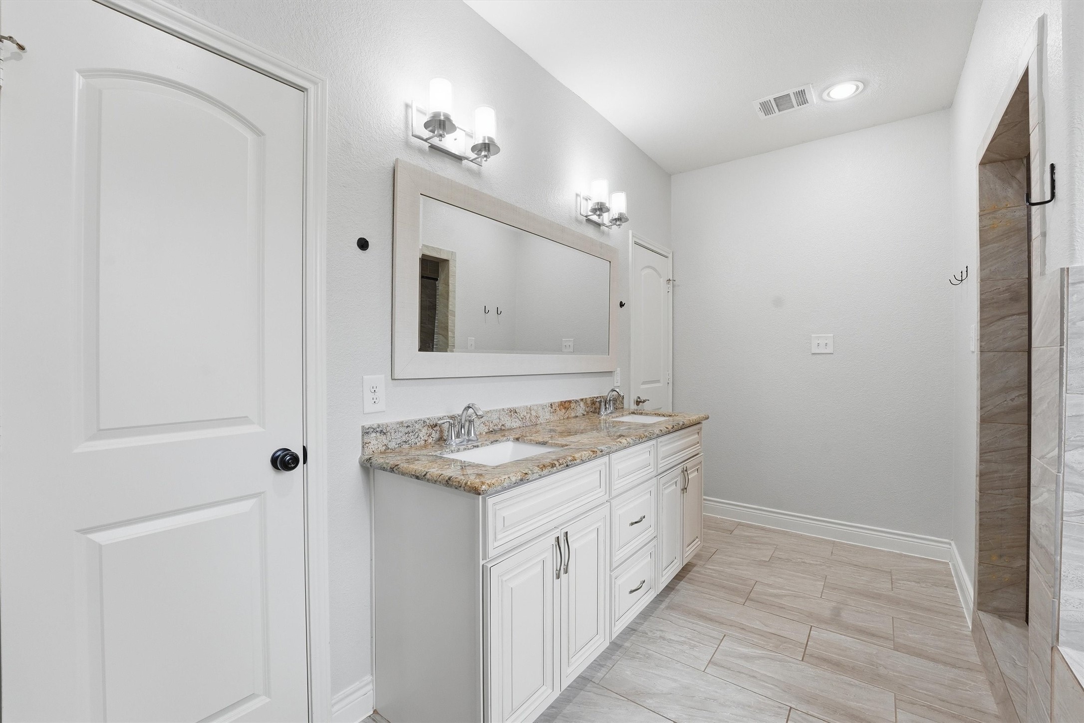 205 Kingspoint Conroe, TX 77356 - Photo 12 of 29 Primary en-suite with dual vanities, separate tub and walk-in shower