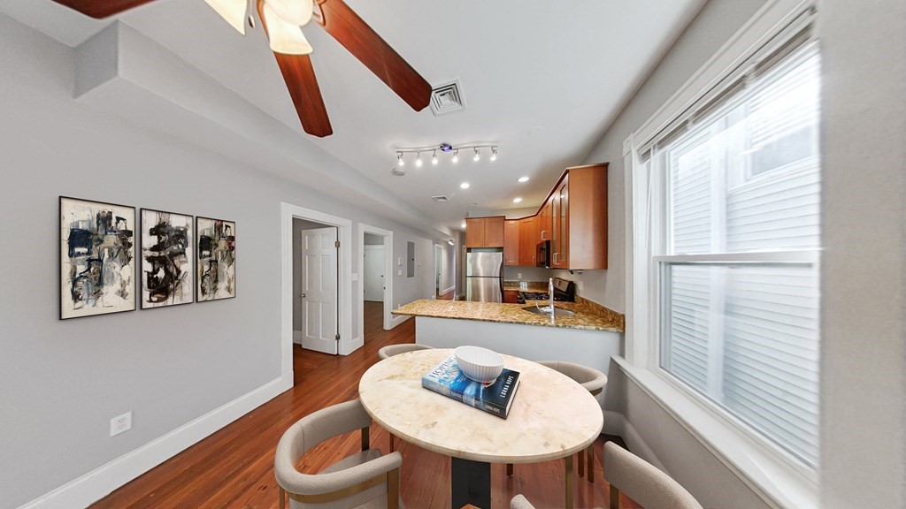 a dining room with furniture and a large window