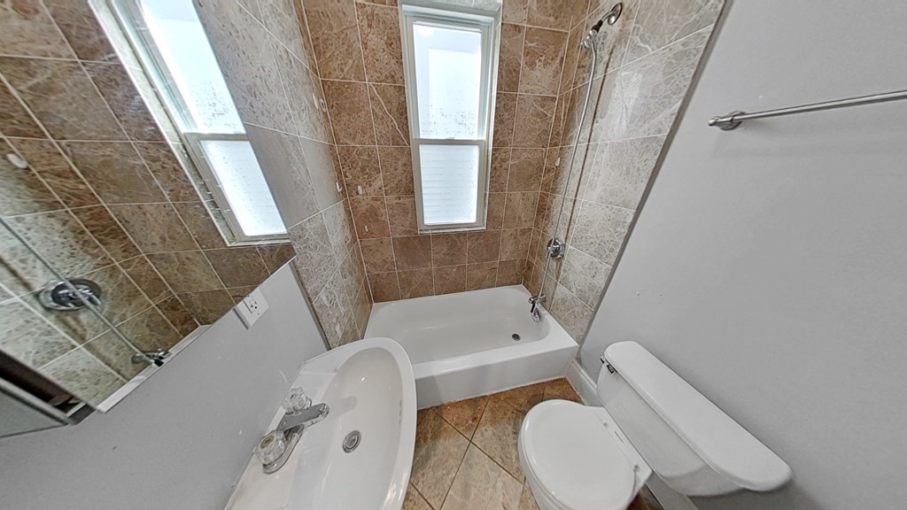 737 Parker Street, Unit 2 Boston, MA 02120 - Photo 11 of 12 a bathroom with a tub a toilet and a sink