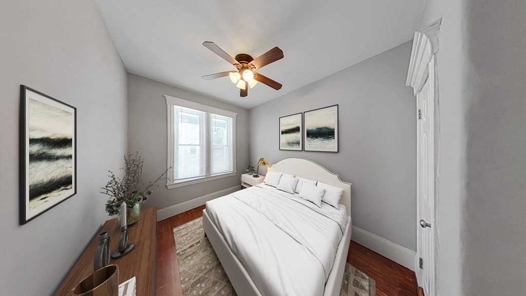 737 Parker Street, Unit 2 Boston, MA 02120 - Photo 5 of 12 a bedroom with a bed and a chandelier