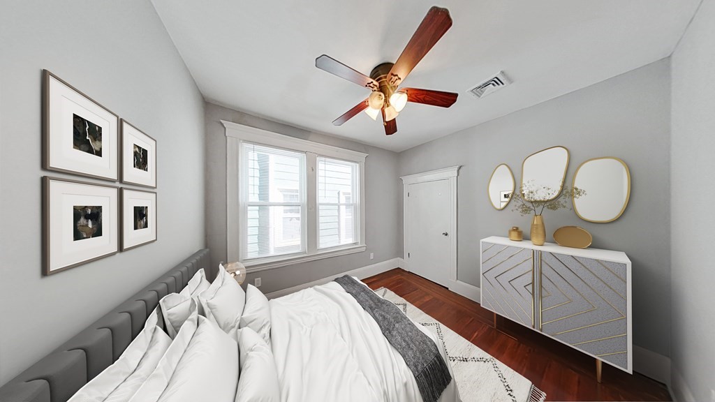 737 Parker Street, Unit 2 Boston, MA 02120 - Photo 9 of 12 a bedroom with a bed mirror and a window