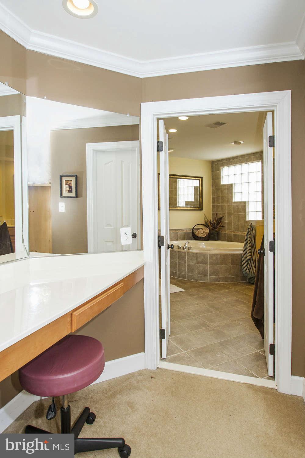 18301 Crestmount Road Boyds, MD 20841 - Photo 22 of 30 a view of a bathroom with a tub shower and a sink