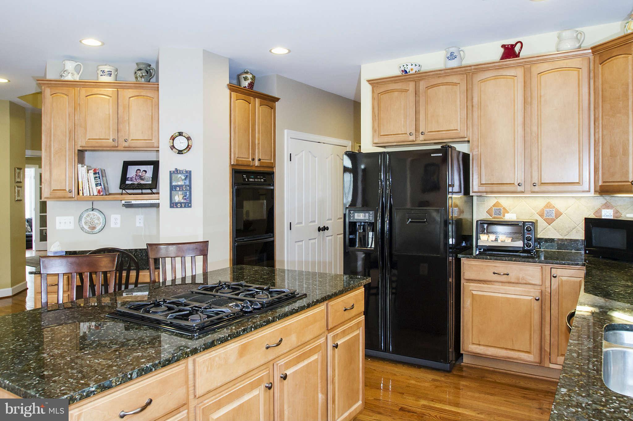 18301 Crestmount Road Boyds, MD 20841 - Photo 8 of 30 a kitchen with stainless steel appliances granite countertop a refrigerator stove and sink