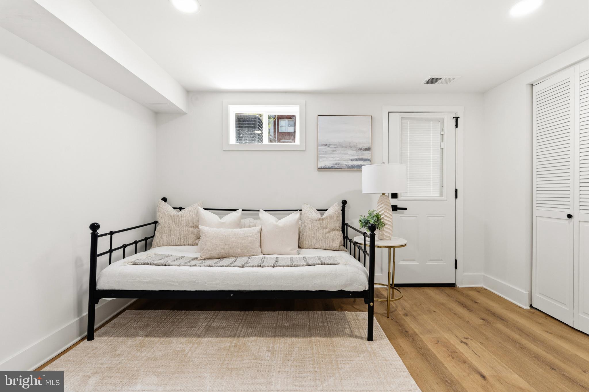 1357 Downing Street Northeast Washington, DC 20018 - Photo 45 of 57 a bedroom with a bed and a lamp