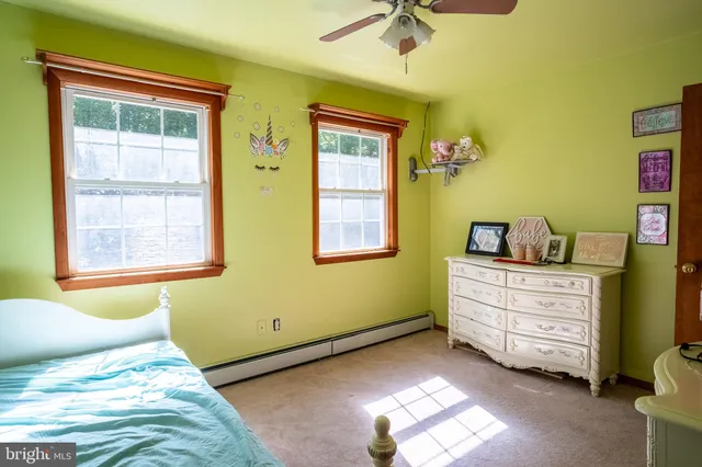 a bed sitting in a bedroom next to a window