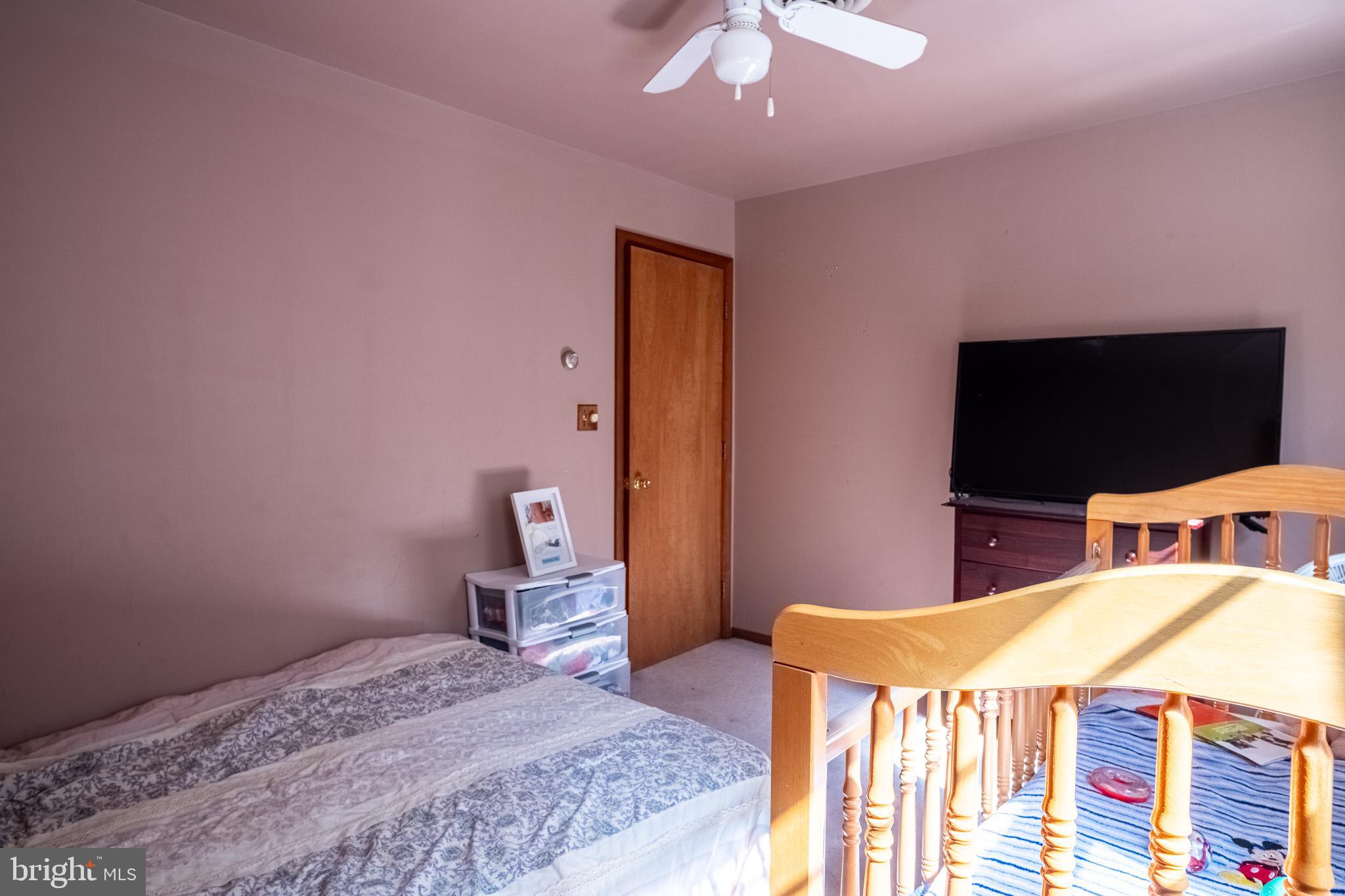 3931 Trego Mountain Road Keedysville, MD 21756 - Photo 21 of 26 a bedroom with a bed and a flat screen tv