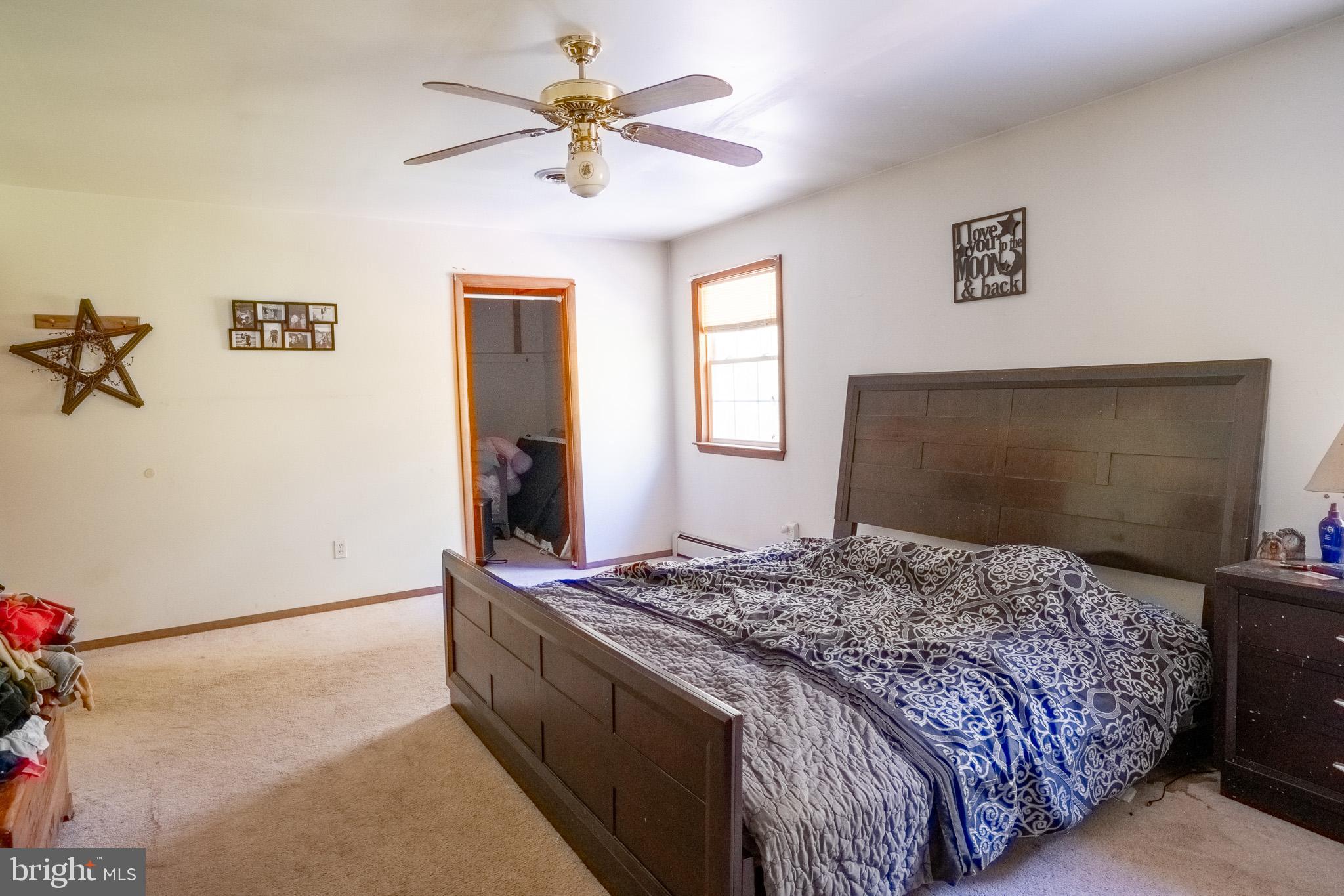 3931 Trego Mountain Road Keedysville, MD 21756 - Photo 26 of 26 a bedroom with a bed and a chandelier