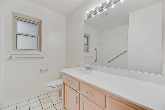 a bathroom with a sink a toilet and vanity