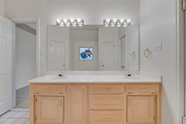 a bathroom with a sink vanity and a mirror