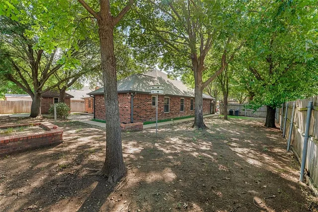 a view of a yard with large tree