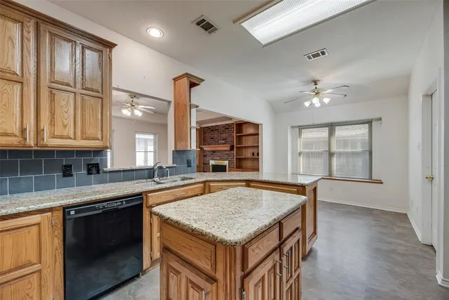 a kitchen with granite countertop a stove and a sink