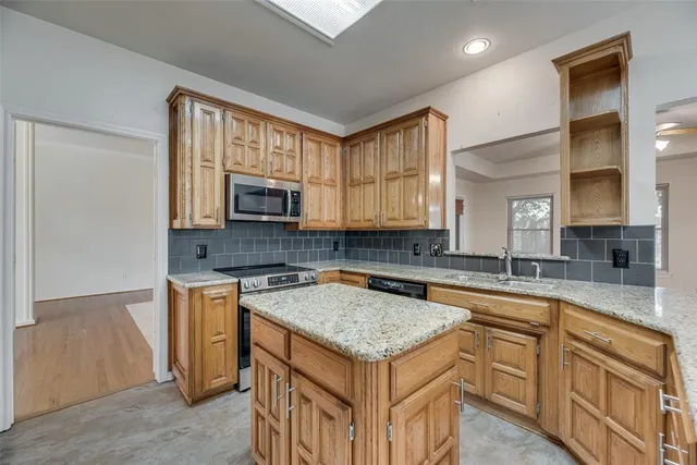 a kitchen with a sink stove and microwave