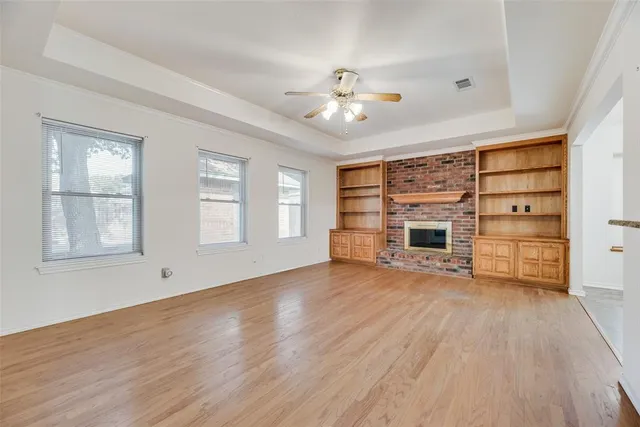 a view of a livingroom with wooden floor closet and windows