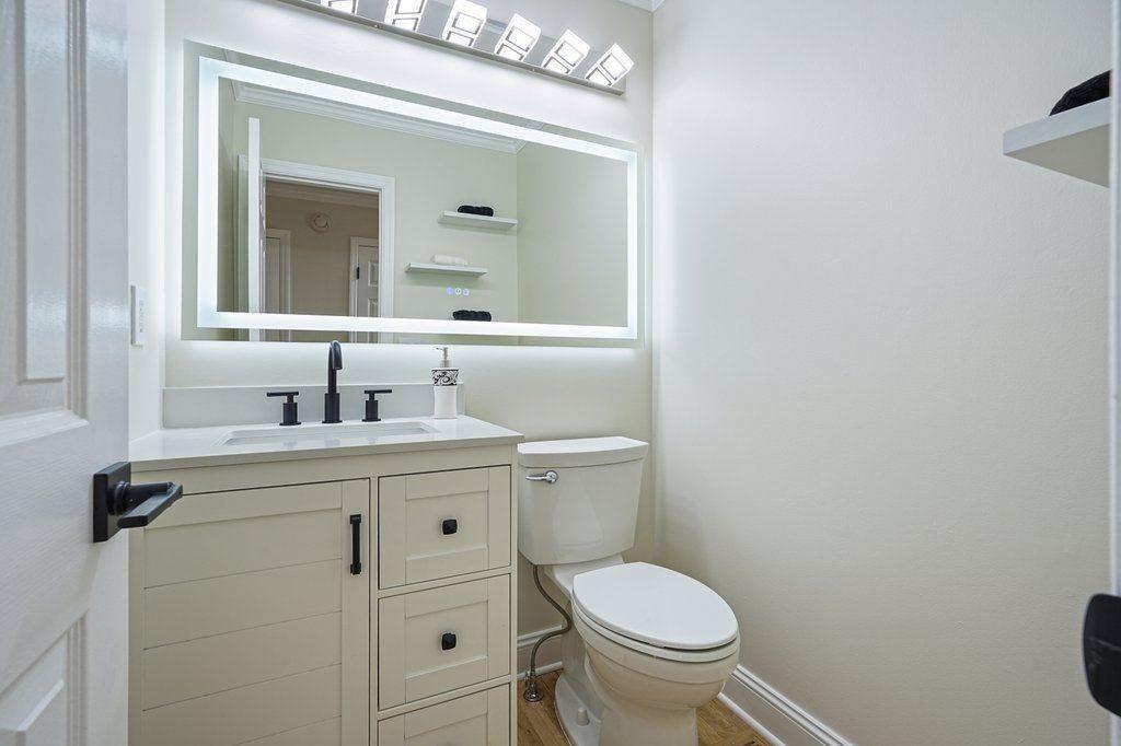 4110 Providence Square Alpharetta, GA 30009 - Photo 21 of 73 a bathroom with a granite countertop toilet sink and mirror