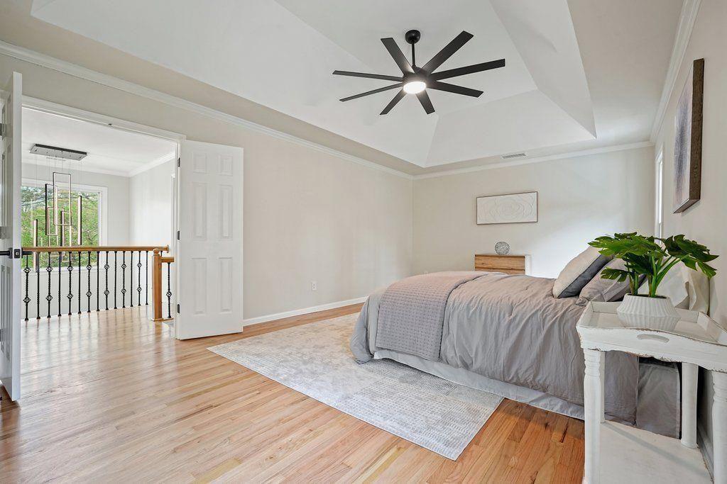 4110 Providence Square Alpharetta, GA 30009 - Photo 25 of 73 a bedroom with a bed and a chandelier