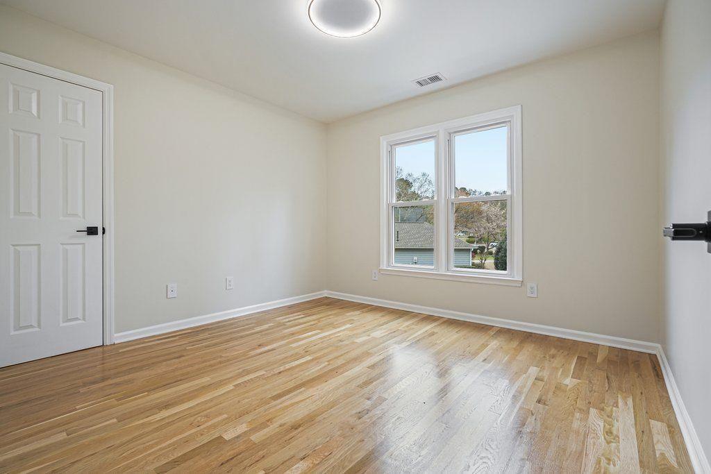 4110 Providence Square Alpharetta, GA 30009 - Photo 32 of 73 a view of an empty room with wooden floor and a window