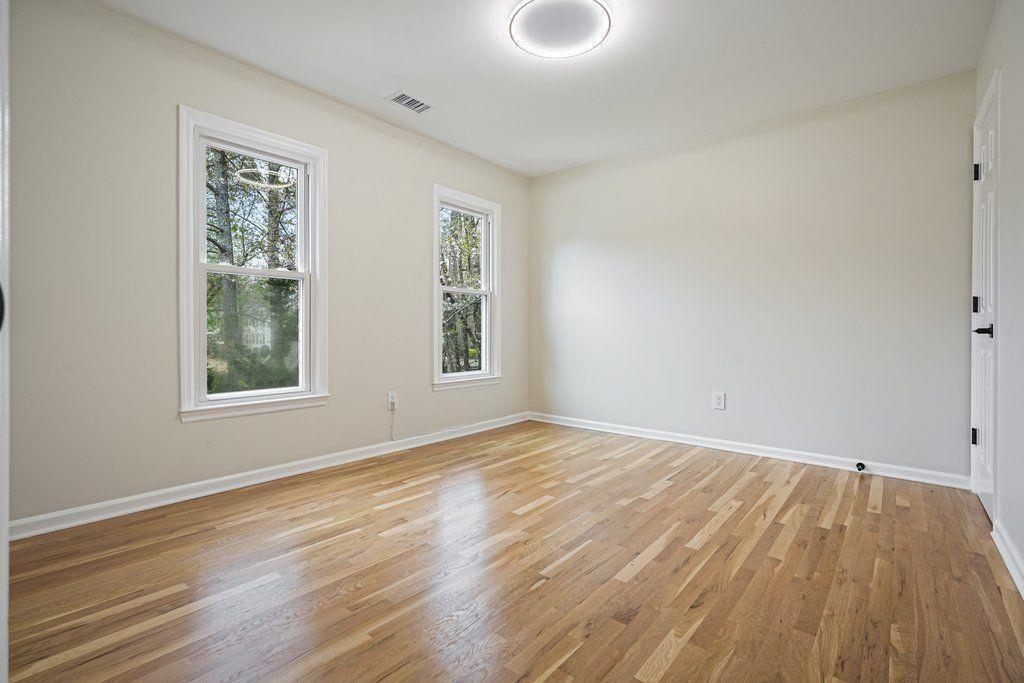 4110 Providence Square Alpharetta, GA 30009 - Photo 35 of 73 a view of an empty room with wooden floor and a window