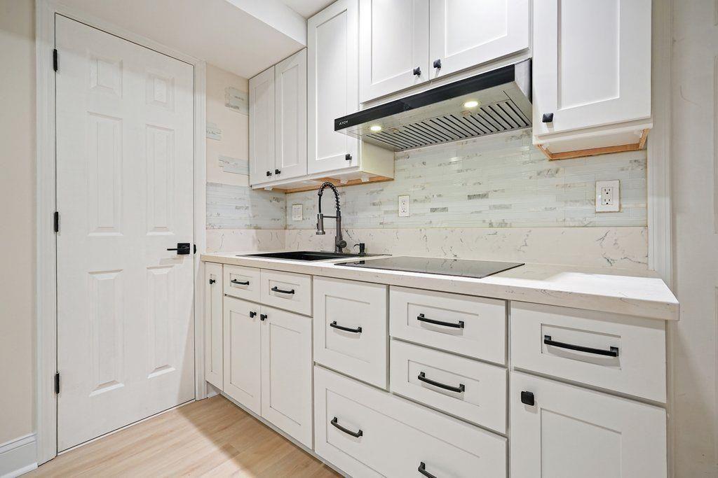 4110 Providence Square Alpharetta, GA 30009 - Photo 49 of 73 a kitchen with white cabinets and white appliances