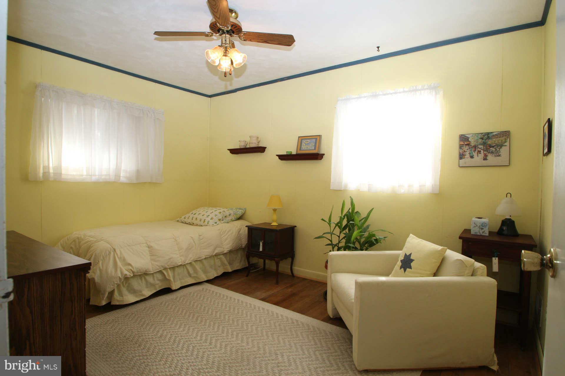 3811 Kayson Street Silver Spring, MD 20906 - Photo 14 of 30 a spacious bedroom with a bed and a chandelier