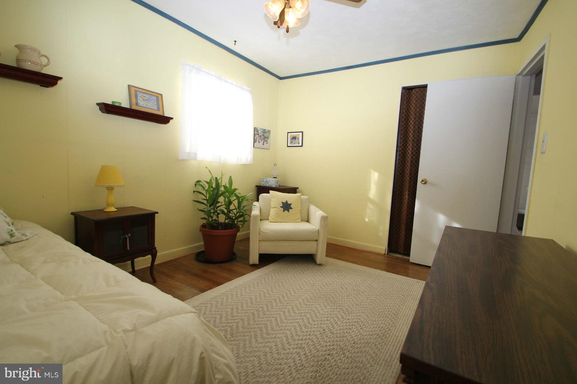 3811 Kayson Street Silver Spring, MD 20906 - Photo 16 of 30 a bedroom with a bed and a chandelier