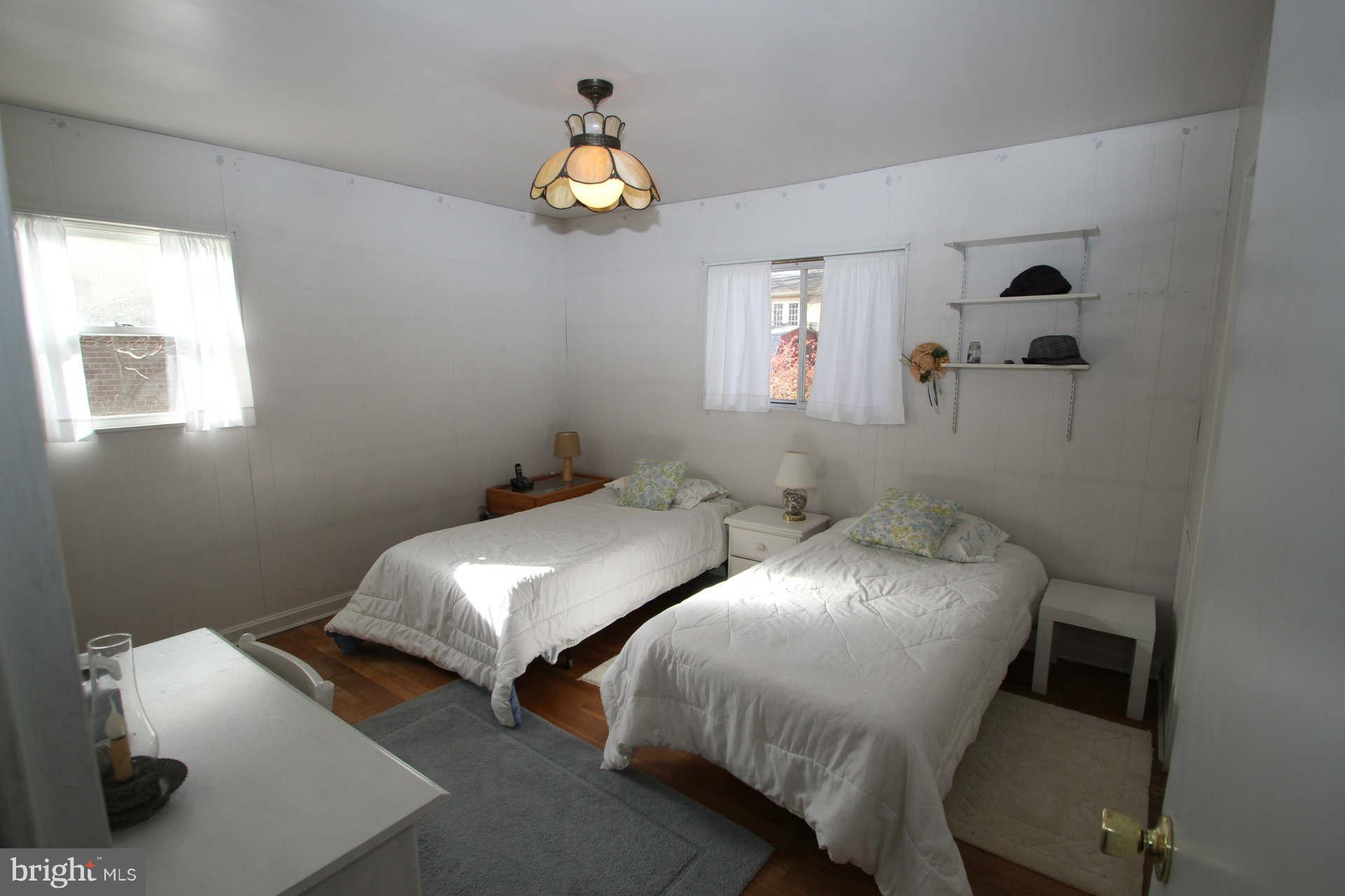 3811 Kayson Street Silver Spring, MD 20906 - Photo 19 of 30 a bedroom with two beds and a lamp