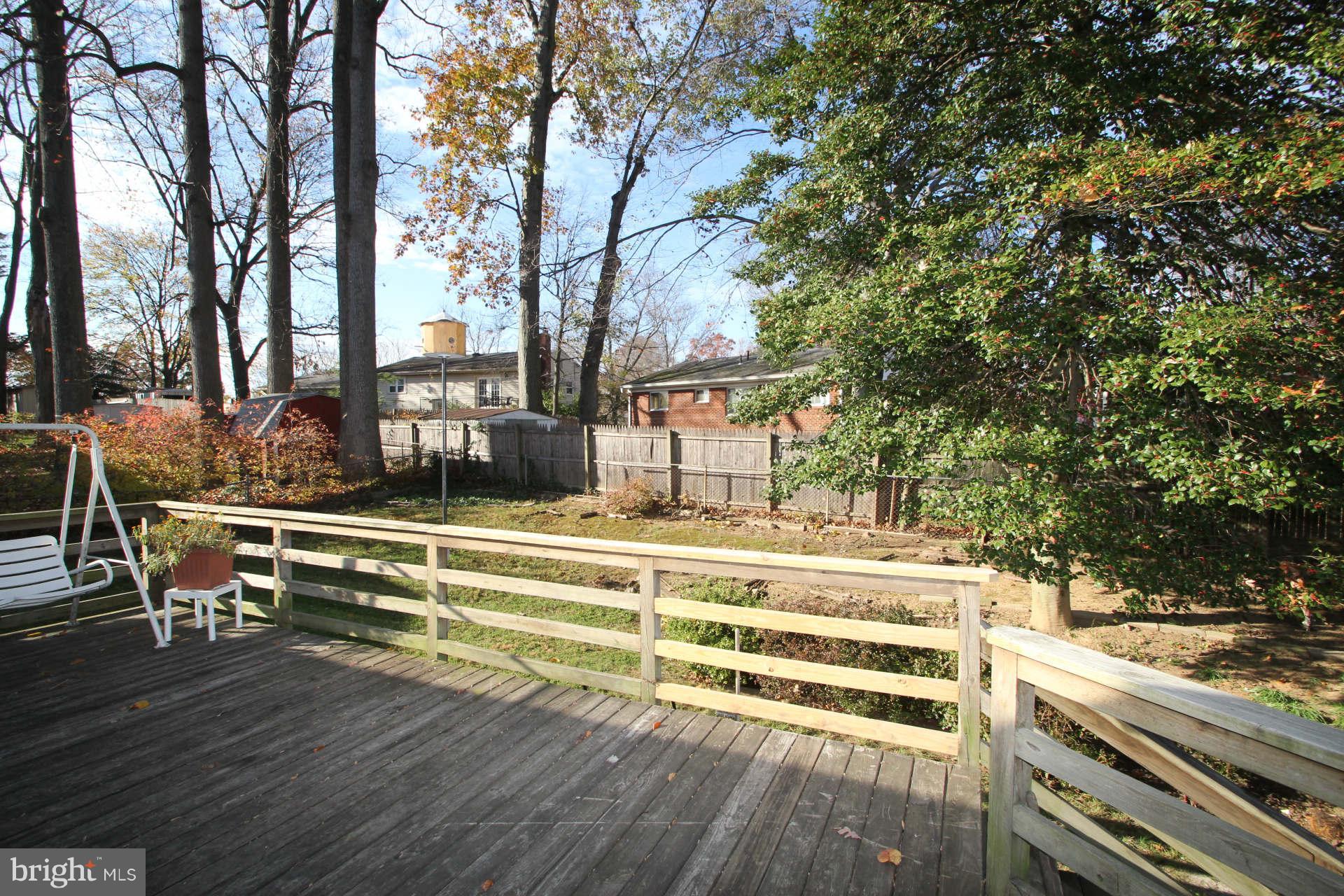 3811 Kayson Street Silver Spring, MD 20906 - Photo 25 of 30 a view of a swimming pool with a bench and trees